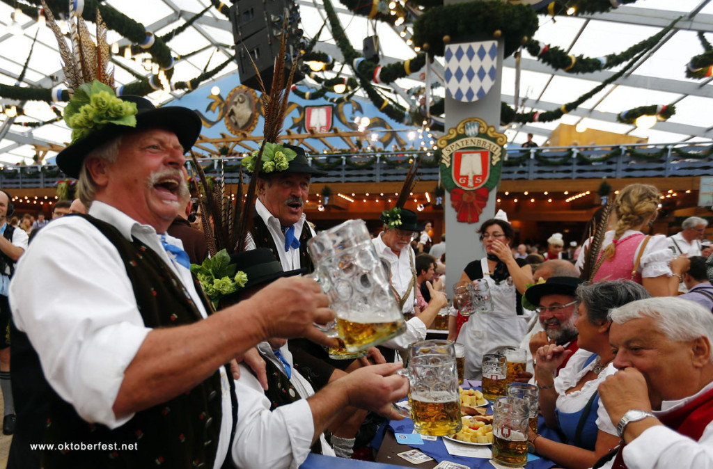 Revellers salute with beer after the opening of the 179th Oktoberfest in Munich